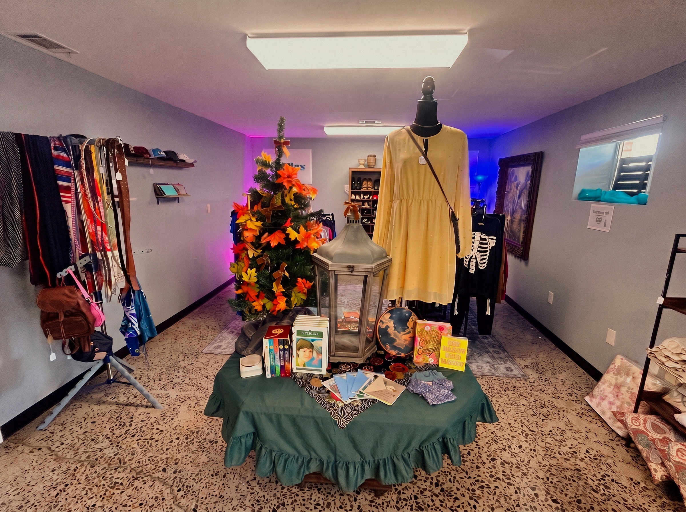 Autumn display table with vintage dress and mannequin in the clothing room