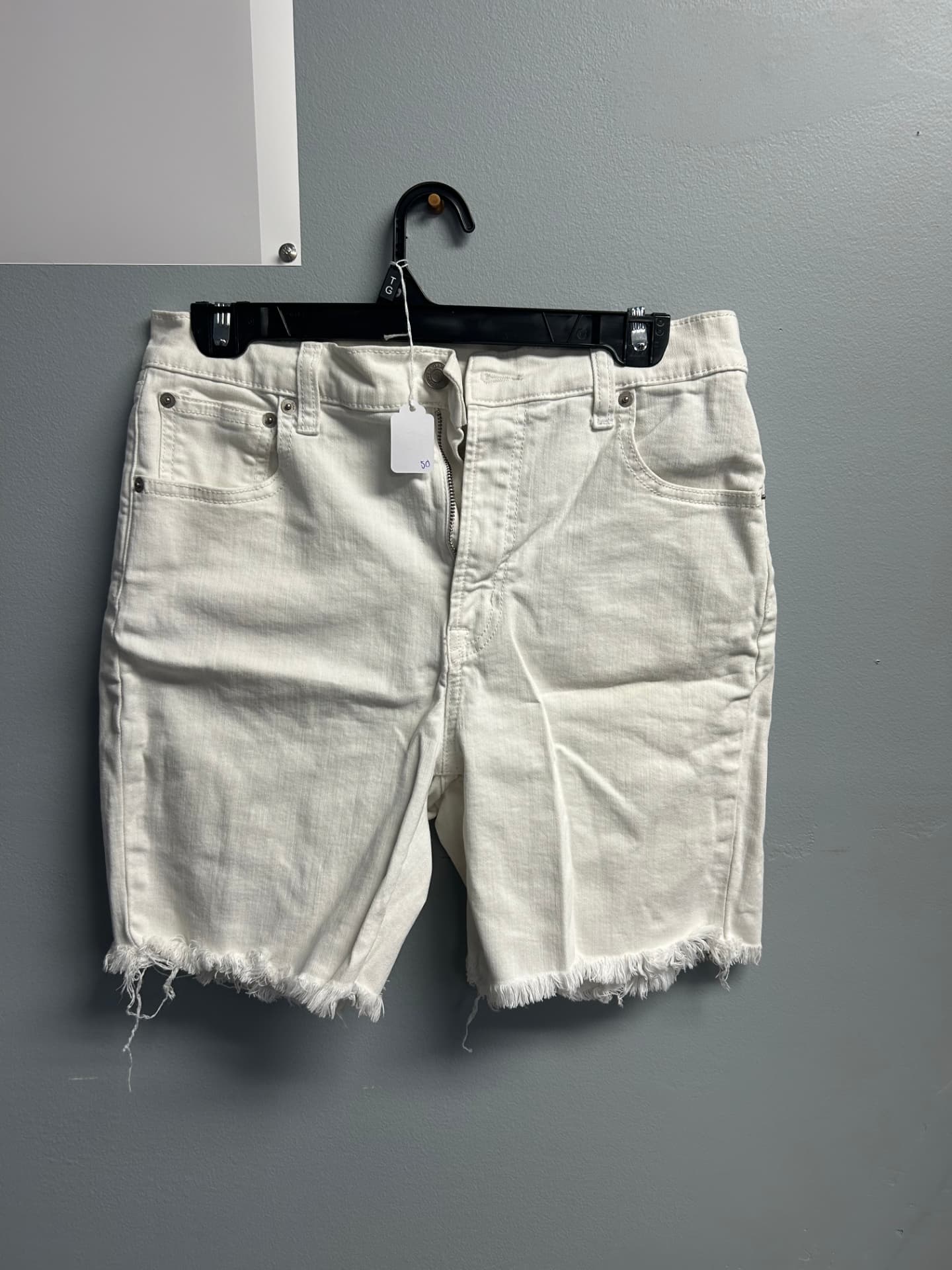 Off-white high-waisted cut-off denim shorts with frayed hems