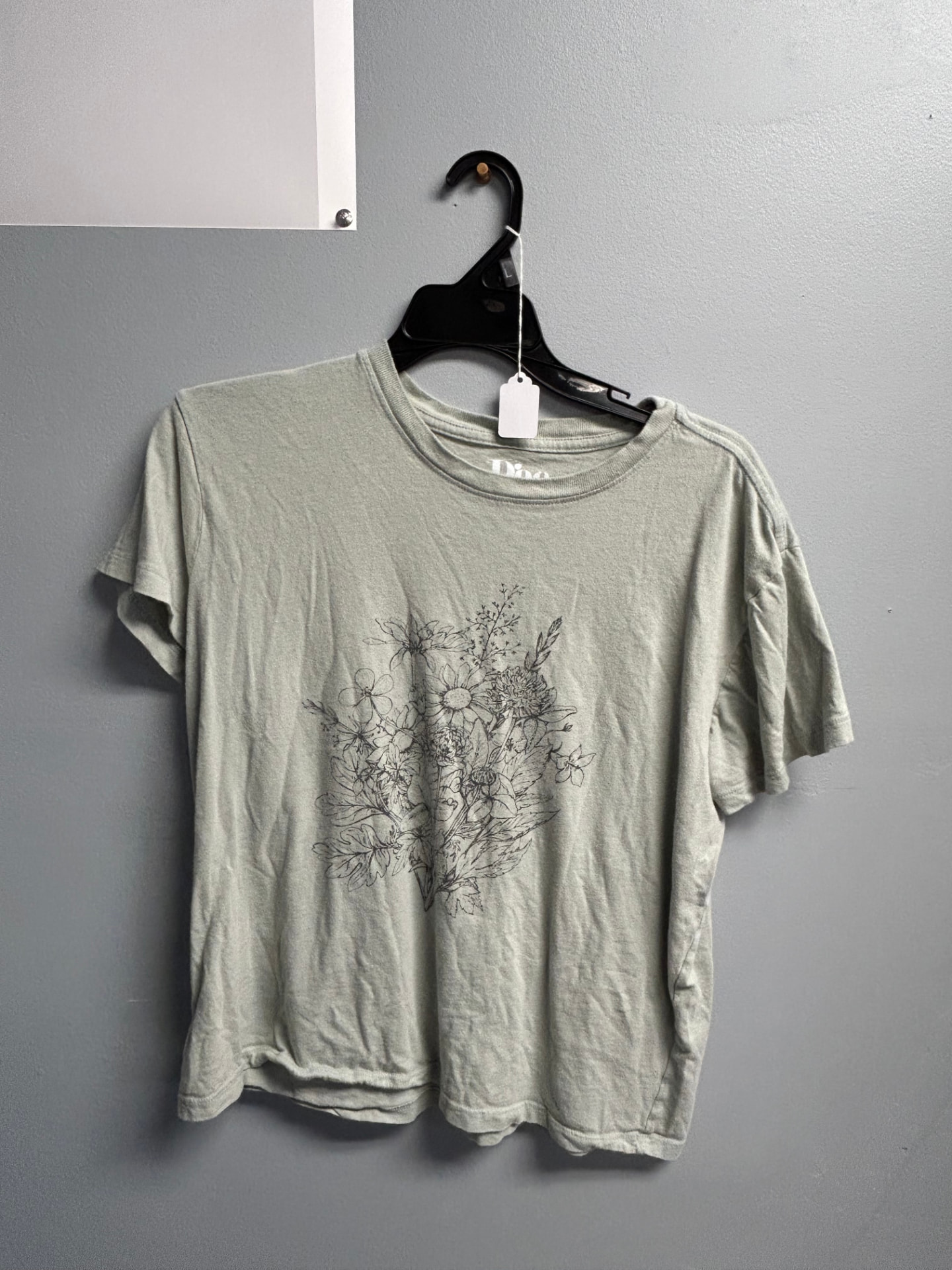 Dusty sage green t-shirt with a black floral graphic