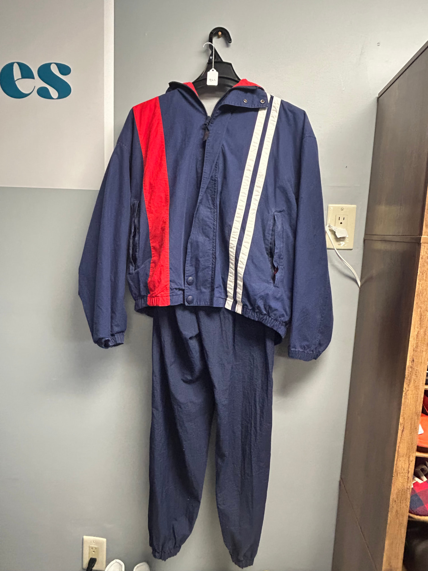 Navy zip-up track jacket and matching pants with red and white stripes, size M