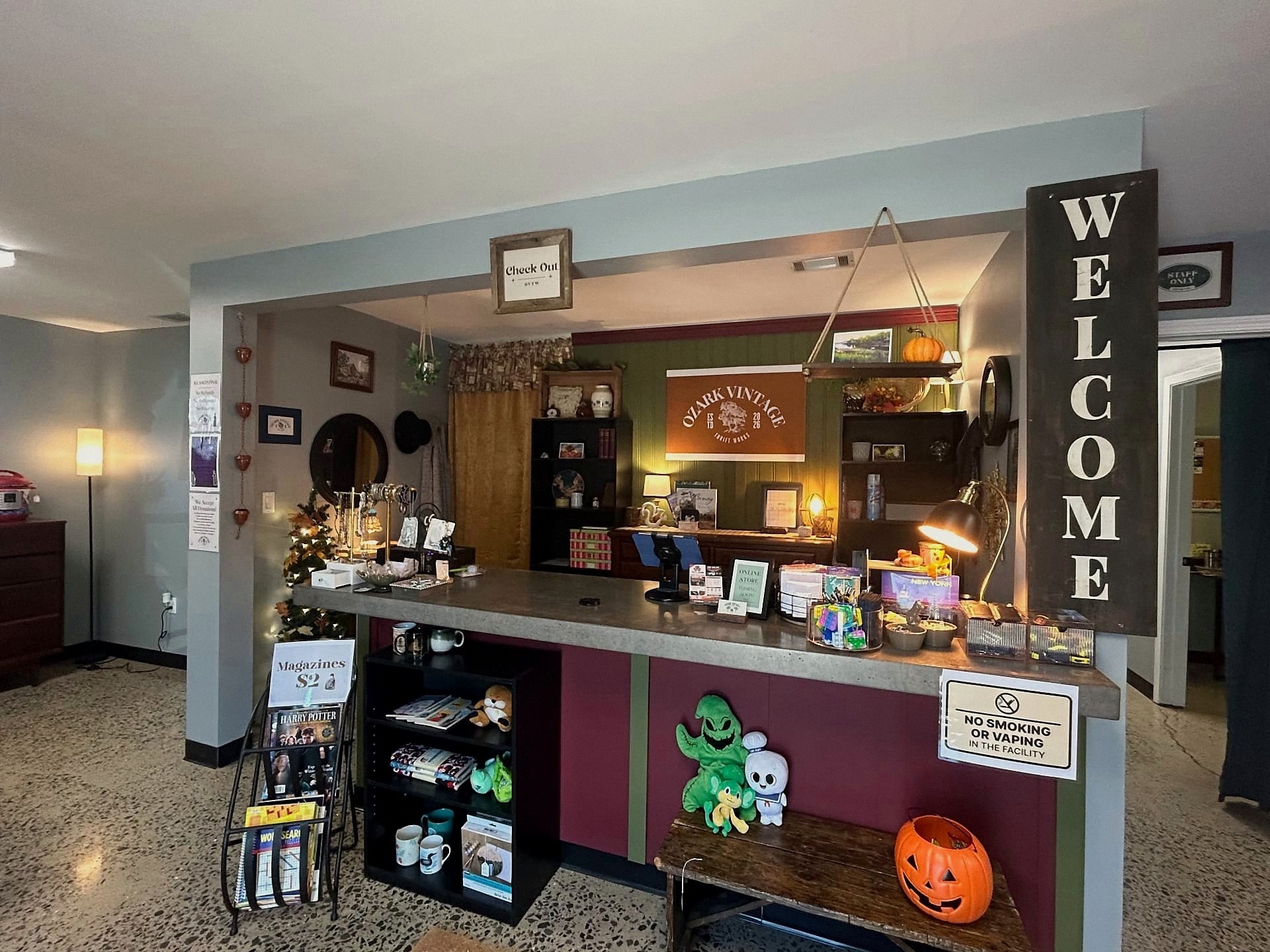 Welcome sign, checkout counter, and Ozark Vintage Thrift Works banner inside the store
