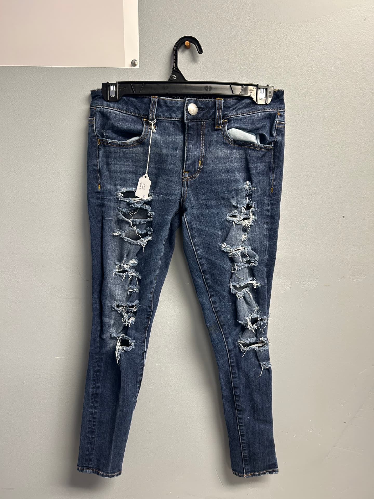 Dark blue skinny jeans with rips down both legs
