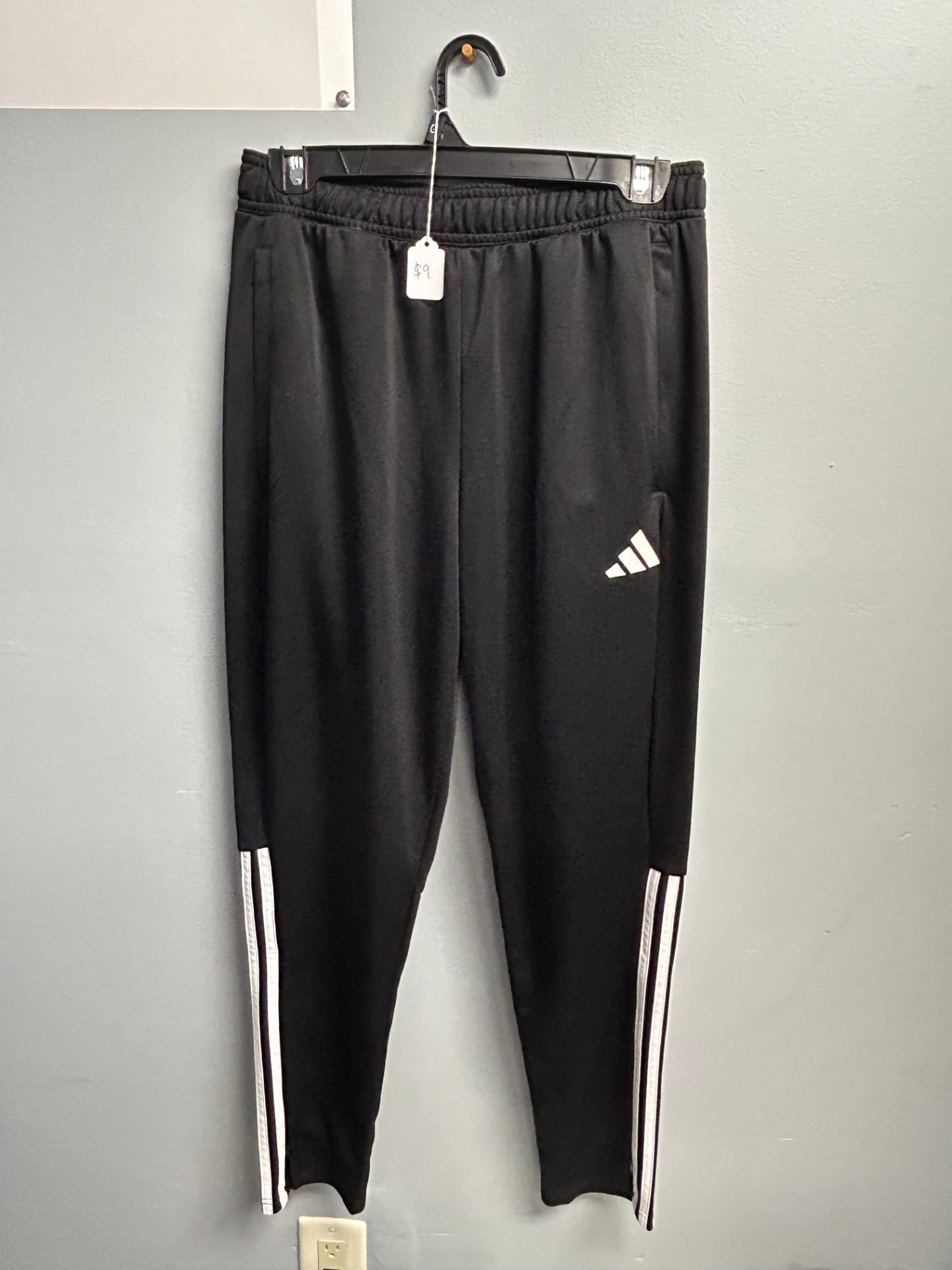 Black Adidas track pants with white stripes