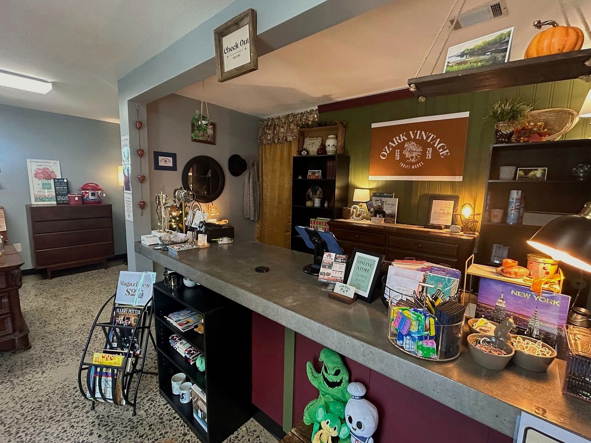 Checkout counter with mugs, records, and store keepsakes