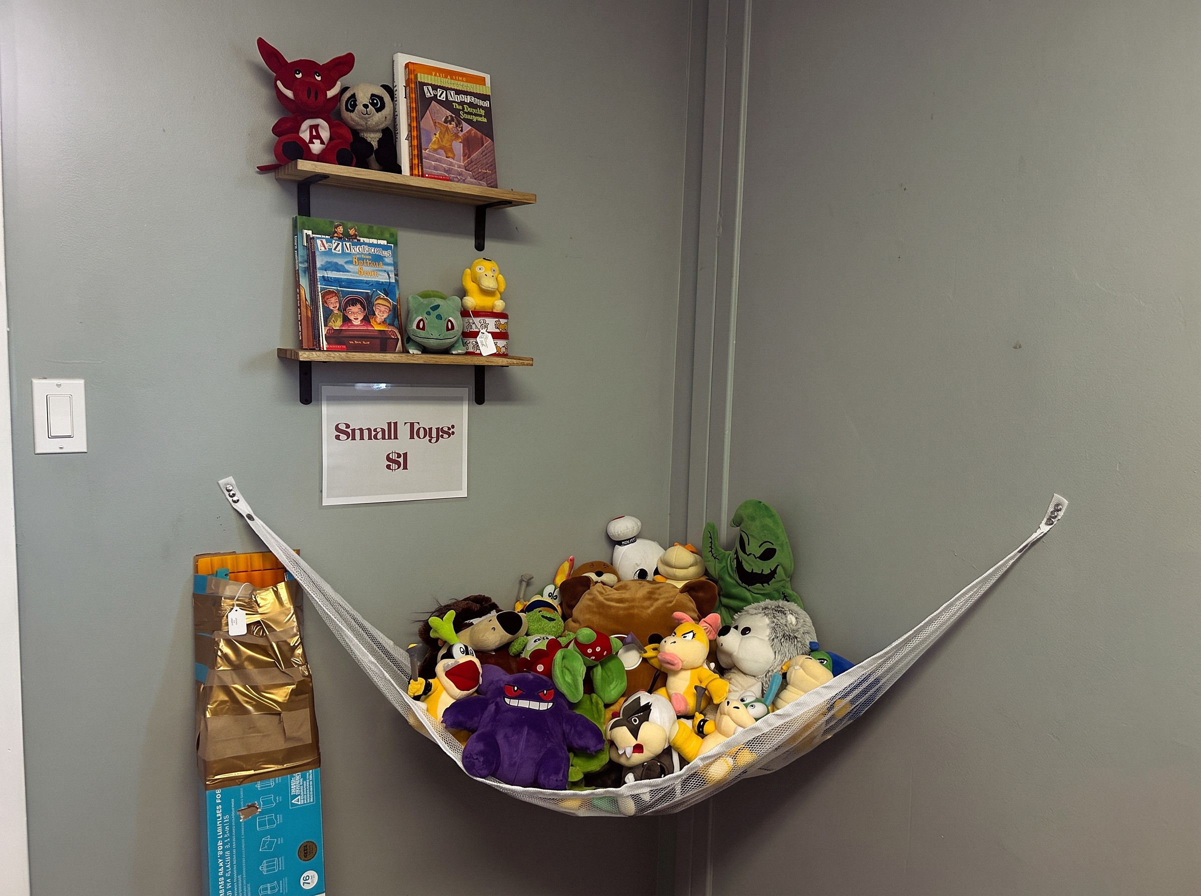 Children's books and small toys displayed inside Ozark Vintage Thrift Works